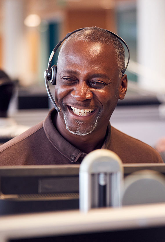 A professional talking on the phone with a headset