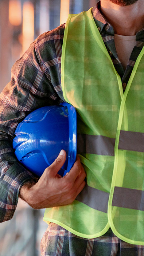 A contractor or construction worker holding a hard hat