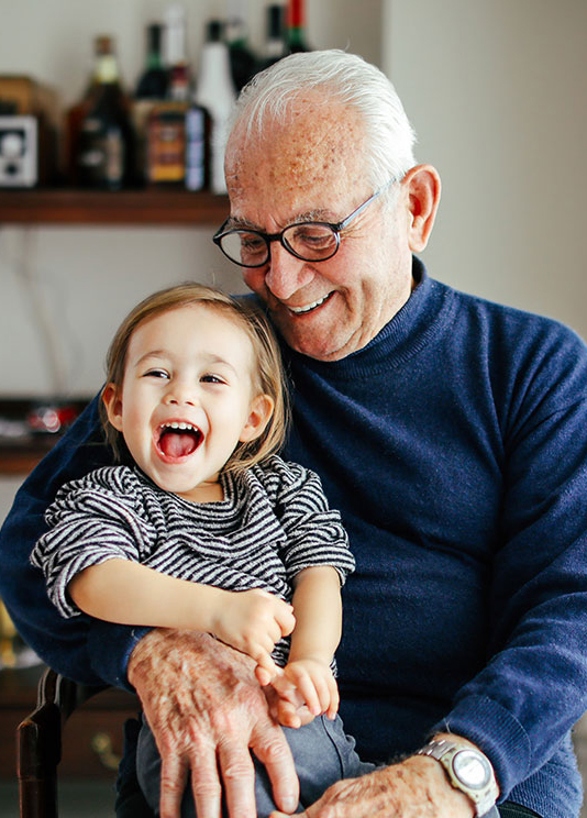 A grandparent holding a happy child