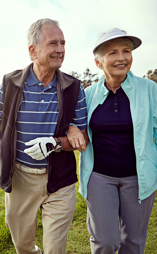 An older couple walking hand-in-hand