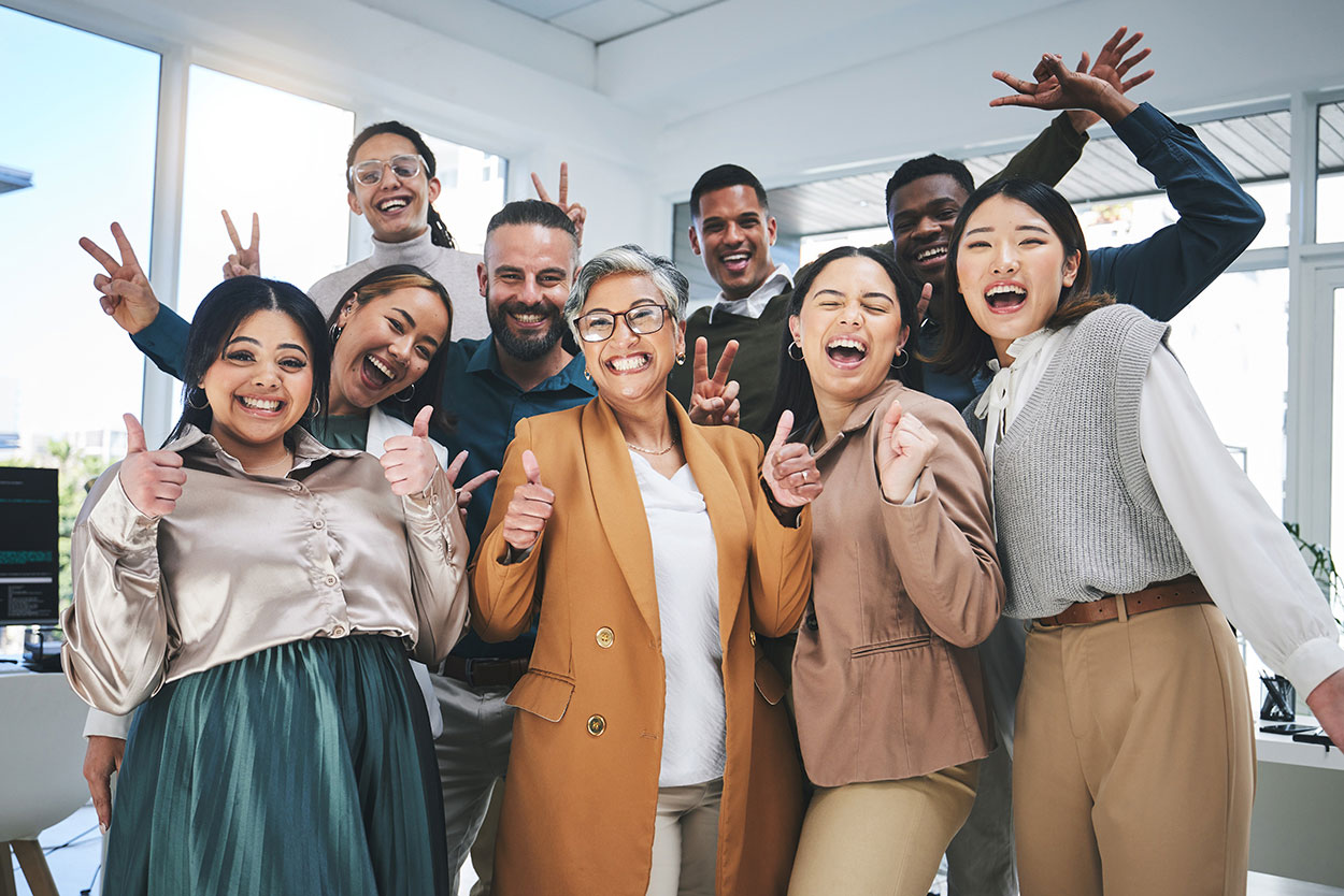 A group of happy employees raising their hands