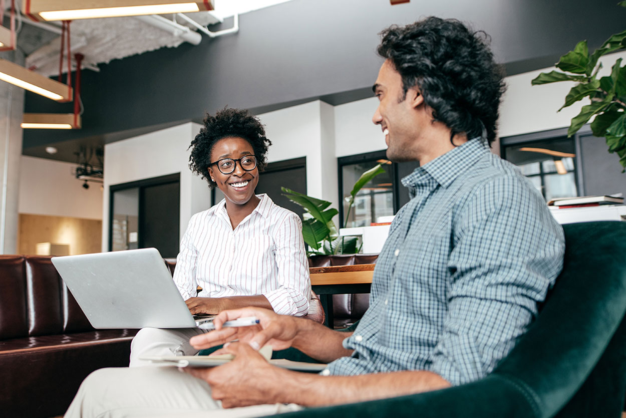 A professional woman talking with a co-worker